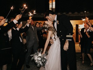 Black tie destination wedding in Cortona villa, couple's kiss under sparklers